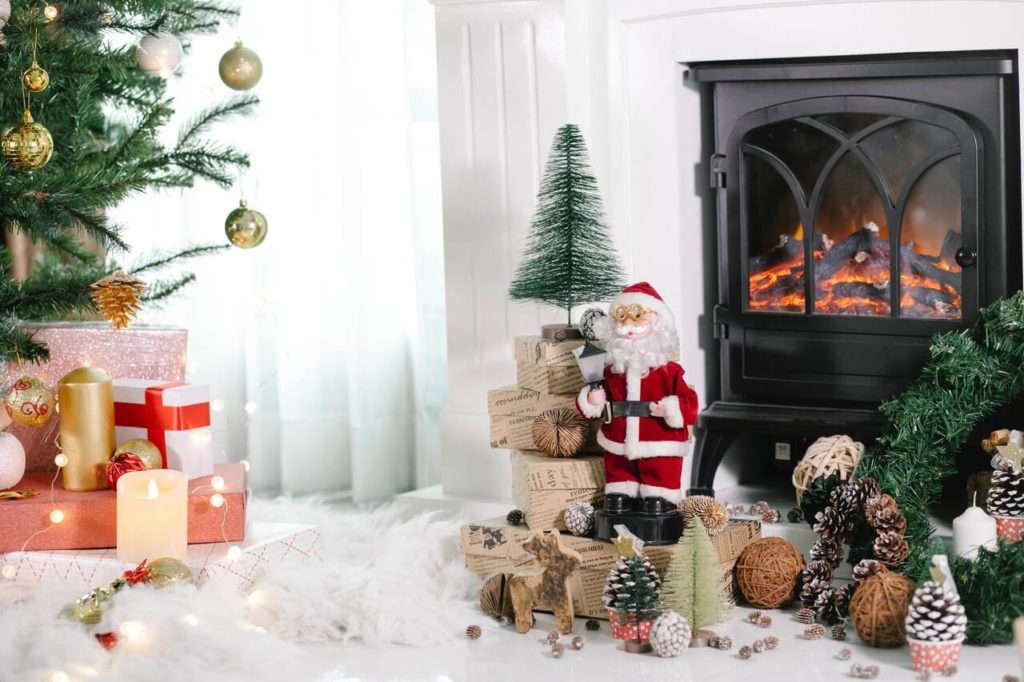 a fireplace with christmas tree and presents