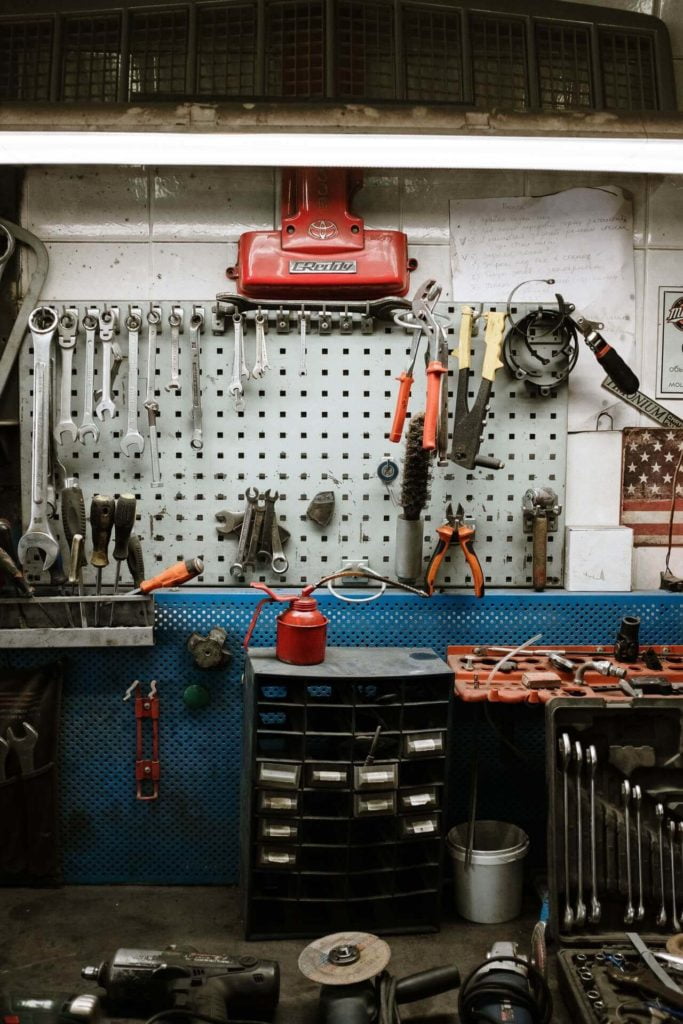 a kitchen with a red stove and a red kettle on the stove