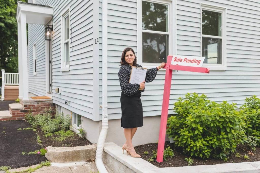 a person standing on a ladder outside a house