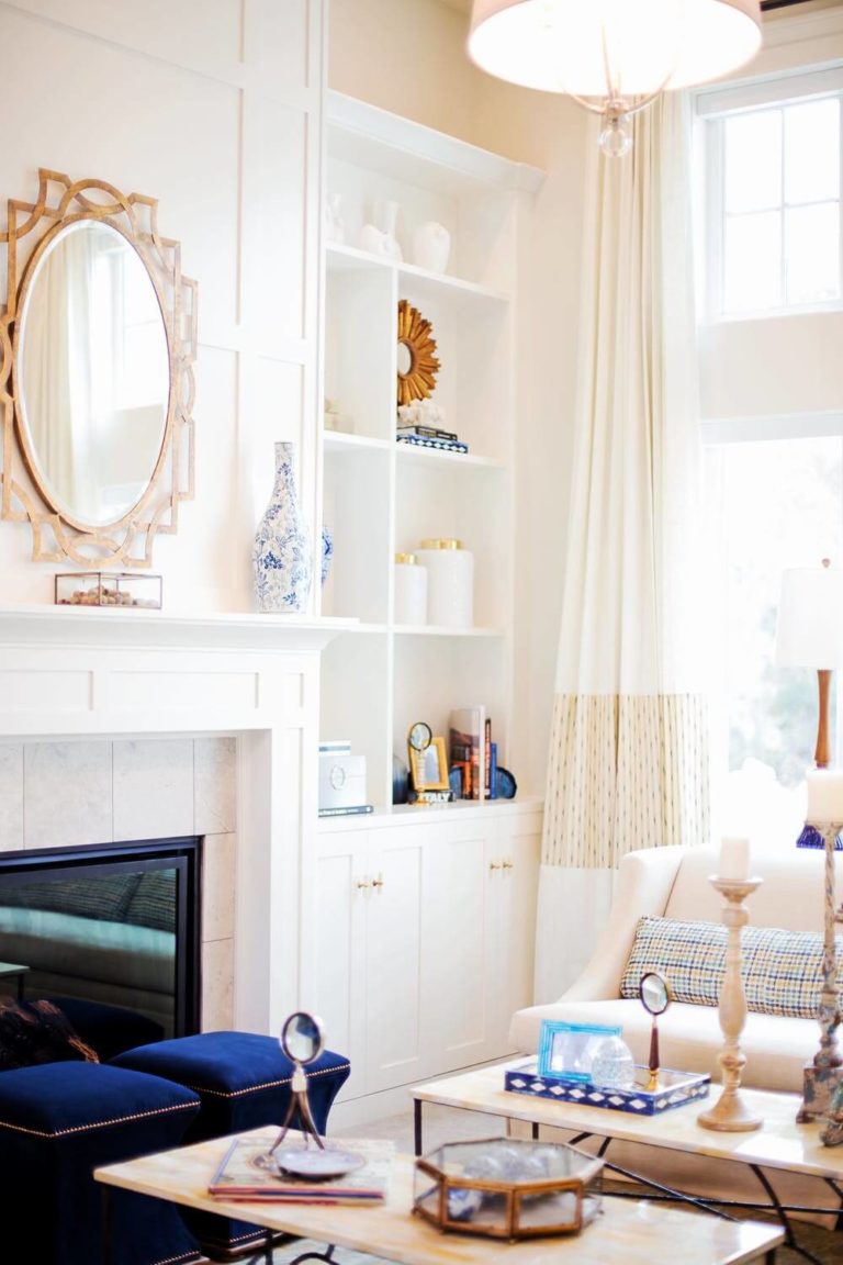 a living room with a mirror and a fireplace