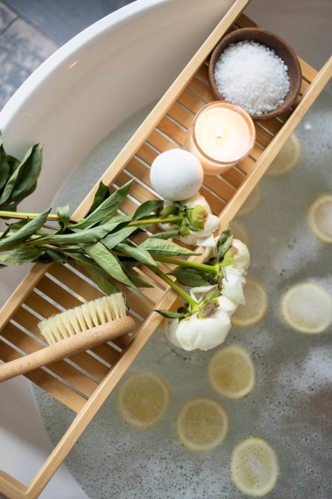 a wooden tray with a white egg and green leaves