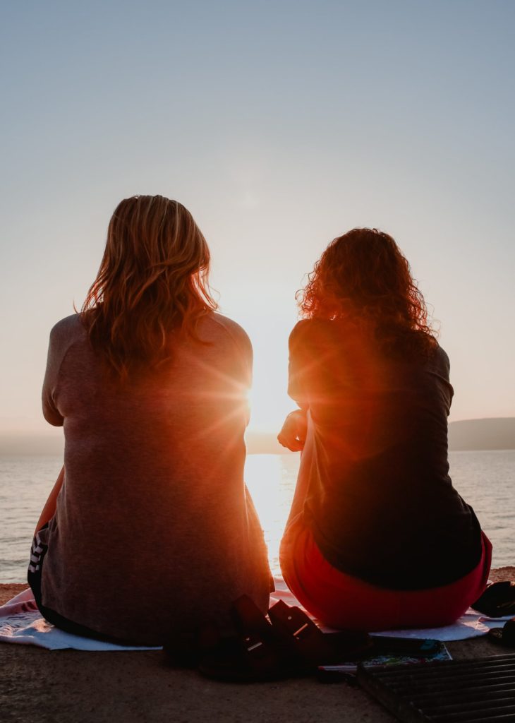 a couple of women sitting on a table