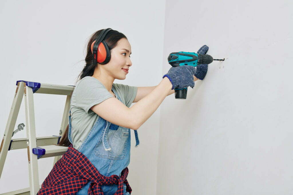 a person wearing a blue and red skirt and holding a vacuum cleaner